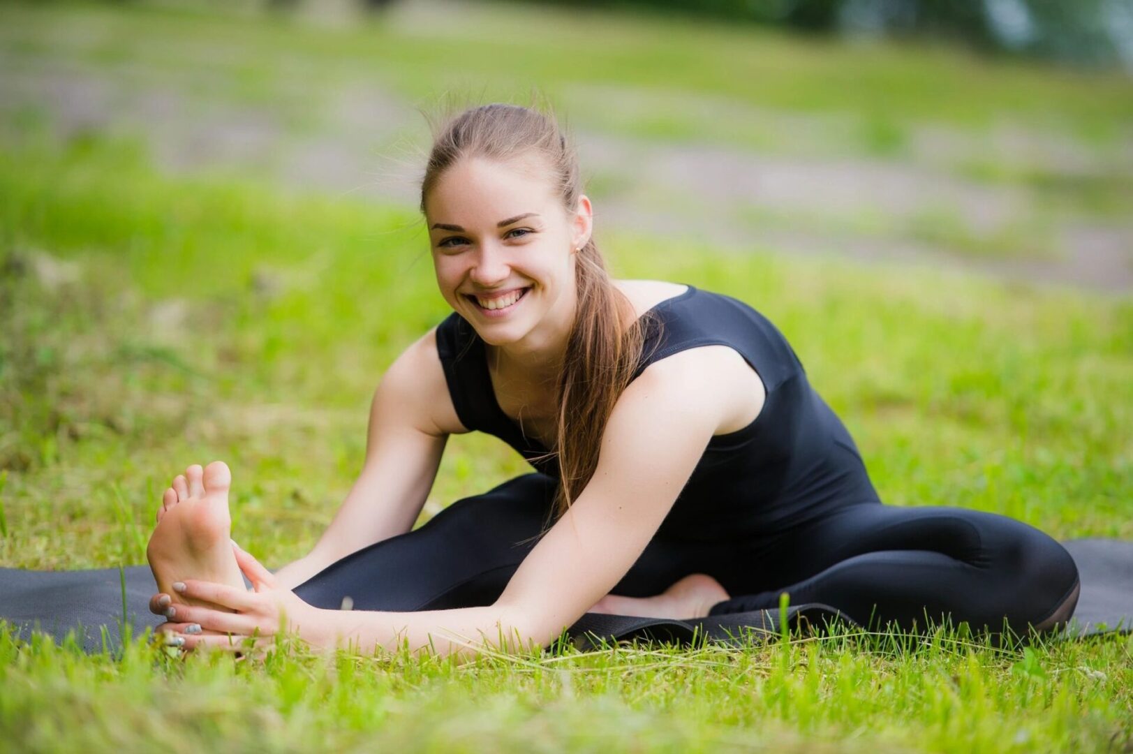 A woman is stretching in the grass